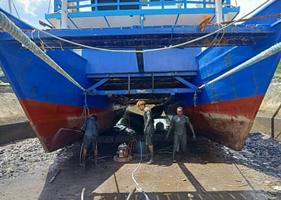 The SEA People Boat Drydock In the Mud Cleaning and Repairing Hulls 4 Reef Restoration Coral Gardeners Raja Ampat