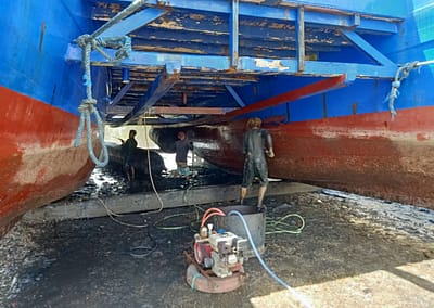 The SEA People Boat Drydock In the Mud Cleaning and Repairing Hulls Reef Restoration Coral Gardeners Raja Ampat